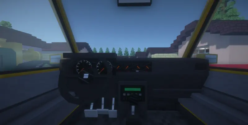 Dashboard view from inside a yellow car with gauges, pedals and a gear shifter