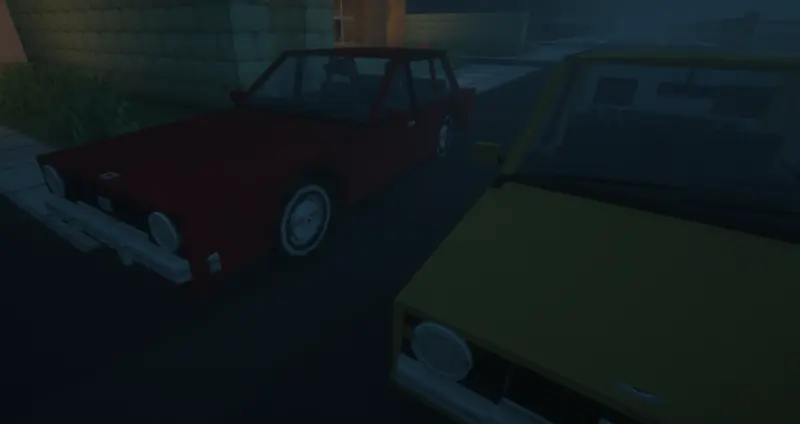 A red car and a yellow car parked on a dark street at night